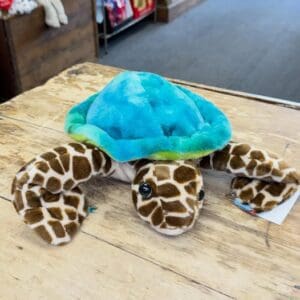 Blue-green plush turtle with giraffe-pattern legs