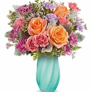 Colorful roses and carnations bouquet in turquoise vase