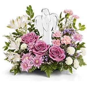 Pink floral arrangement with glass angel