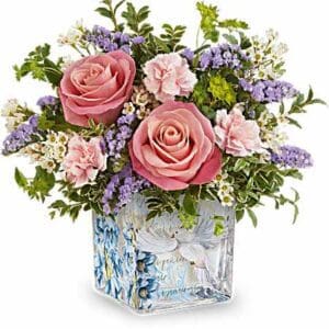 Pink rose bouquet in dove-decorated glass vase