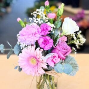 Pink mixed flower bouquet in glass jar