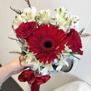 Red gerbera and roses bouquet with ribbon